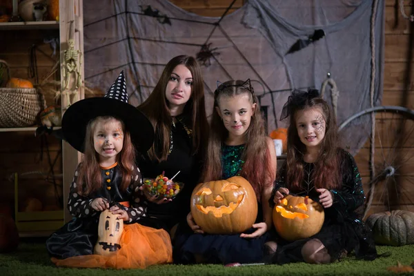 Mom and children preparing for the holiday of Halloween