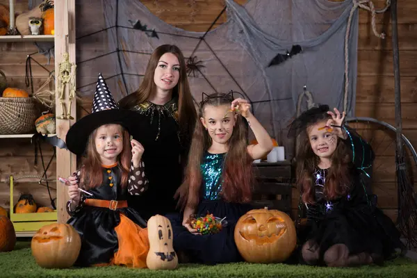 Mom and children preparing for the holiday of Halloween