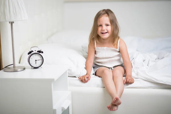 A girl of four years old sleeps in bed