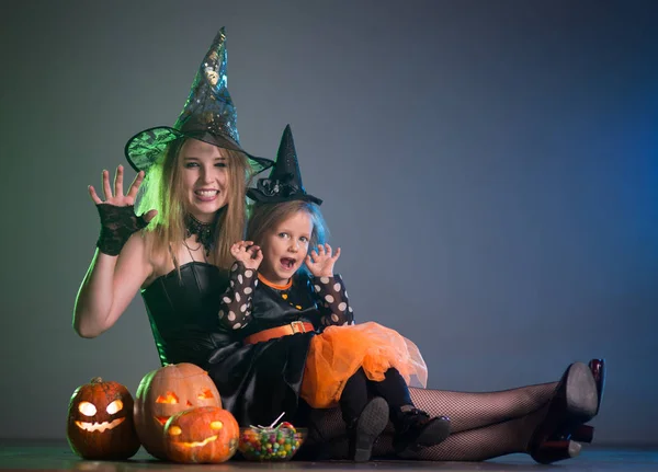 Mom and daughter in costumes for a holiday of halloween