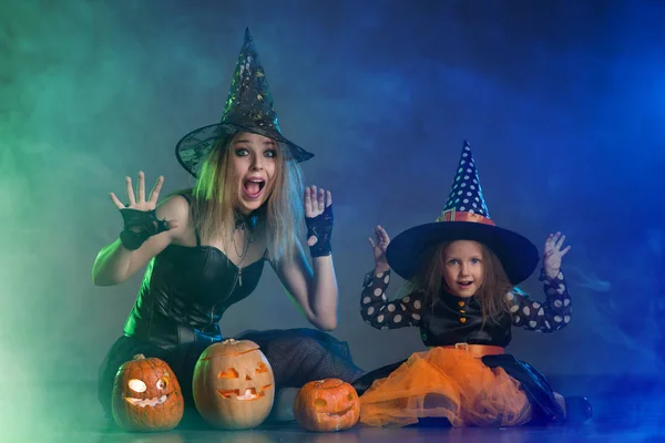 Mom and daughter in costumes for a holiday of halloween