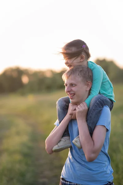 Brother and younger sister in the field