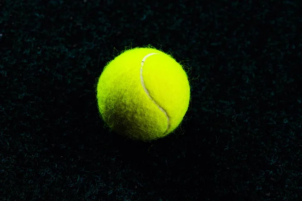 Tennis Ball isolated on black with dramatic lighting — Stock Photo, Image