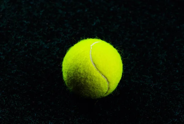 stock image Tennis Ball isolated on black with dramatic lighting