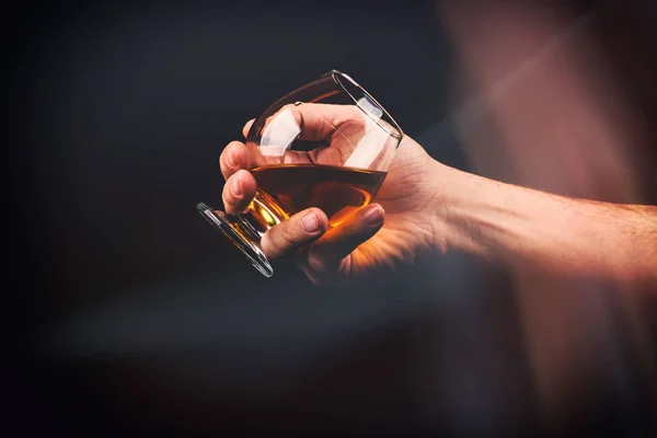 Cognac glass in a hand of a man — Stock Photo, Image