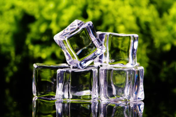 Ice cubes on a green background — Stock Photo, Image