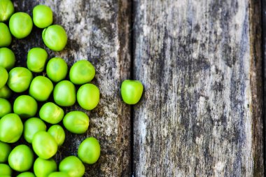 Ahşap arka planda yeşil bezelye. Sağlıklı yiyecekler. Koyu rustik tarzı