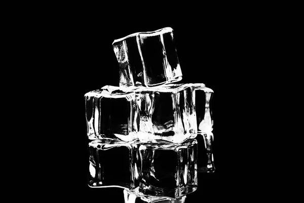 Ice cubes on reflection table on black background — Stock Photo, Image