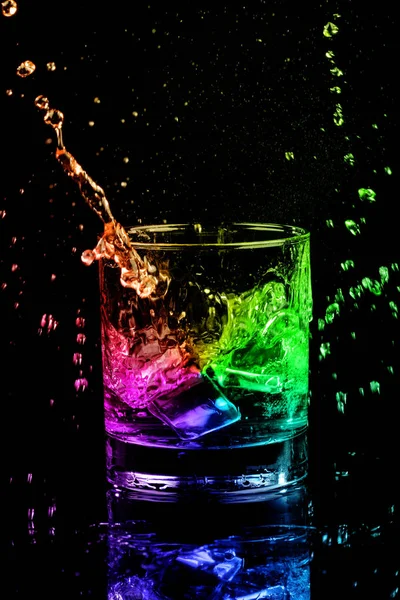 Isolated shot of whiskey with splash on black background — Stock Photo, Image