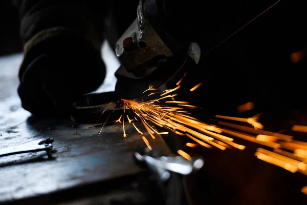 Metal grinding on steel pipe with flash of sparks close up — Stock Photo, Image