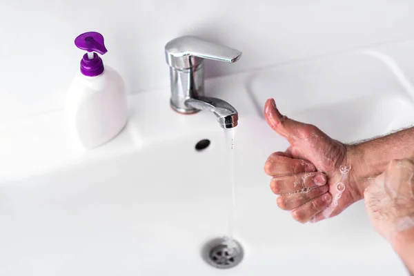 Like for washing hands. Man is washing his hands in a sink for sanitation and reducing the spread of COVID-19 spreading. Hygiene and Sanitation concept.