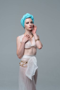 Genç güzel kız beyaz şeffaf iç çamaşırlarıyla ayakta stüdyoda poz