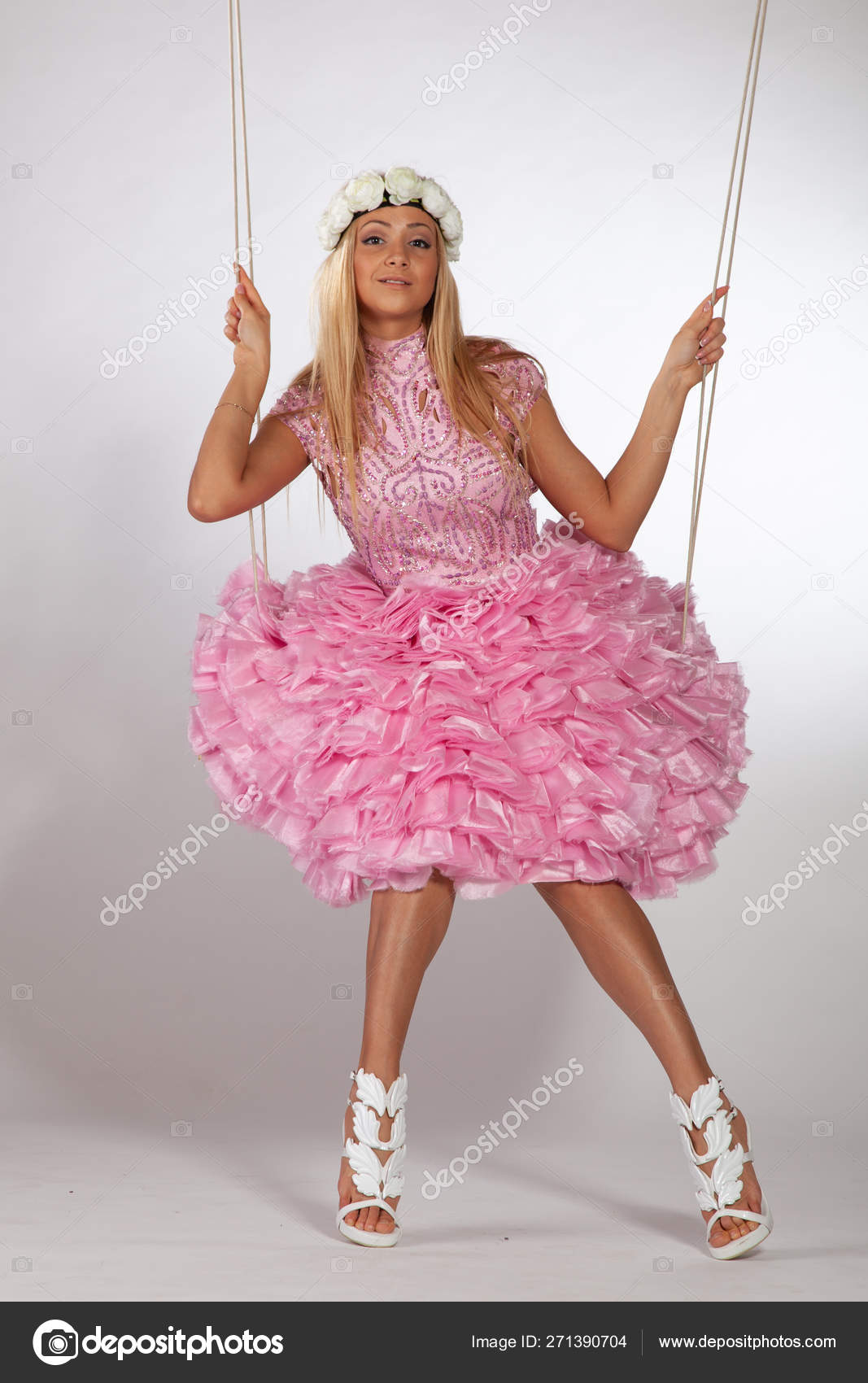 https://st4.depositphotos.com/10086424/27139/i/1600/depositphotos_271390704-stock-photo-girl-swinging-swing-studio-pink.jpg