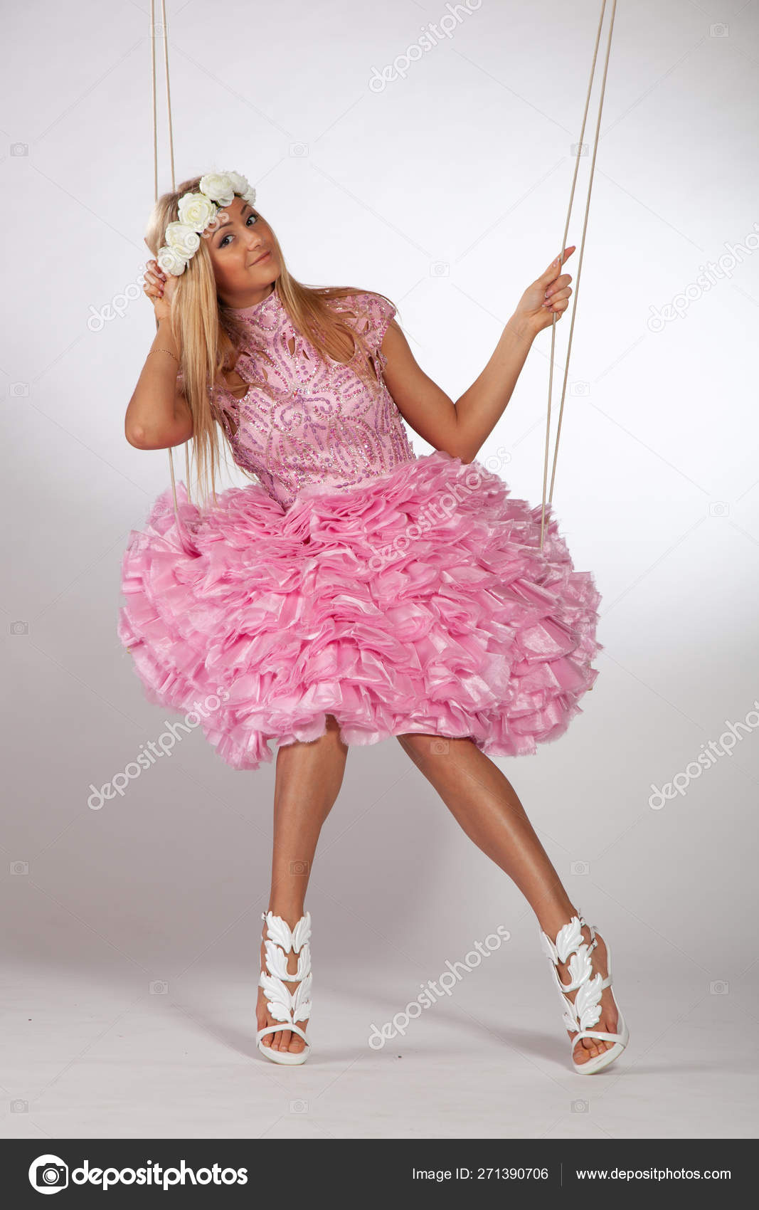 https://st4.depositphotos.com/10086424/27139/i/1600/depositphotos_271390706-stock-photo-girl-swinging-swing-studio-pink.jpg