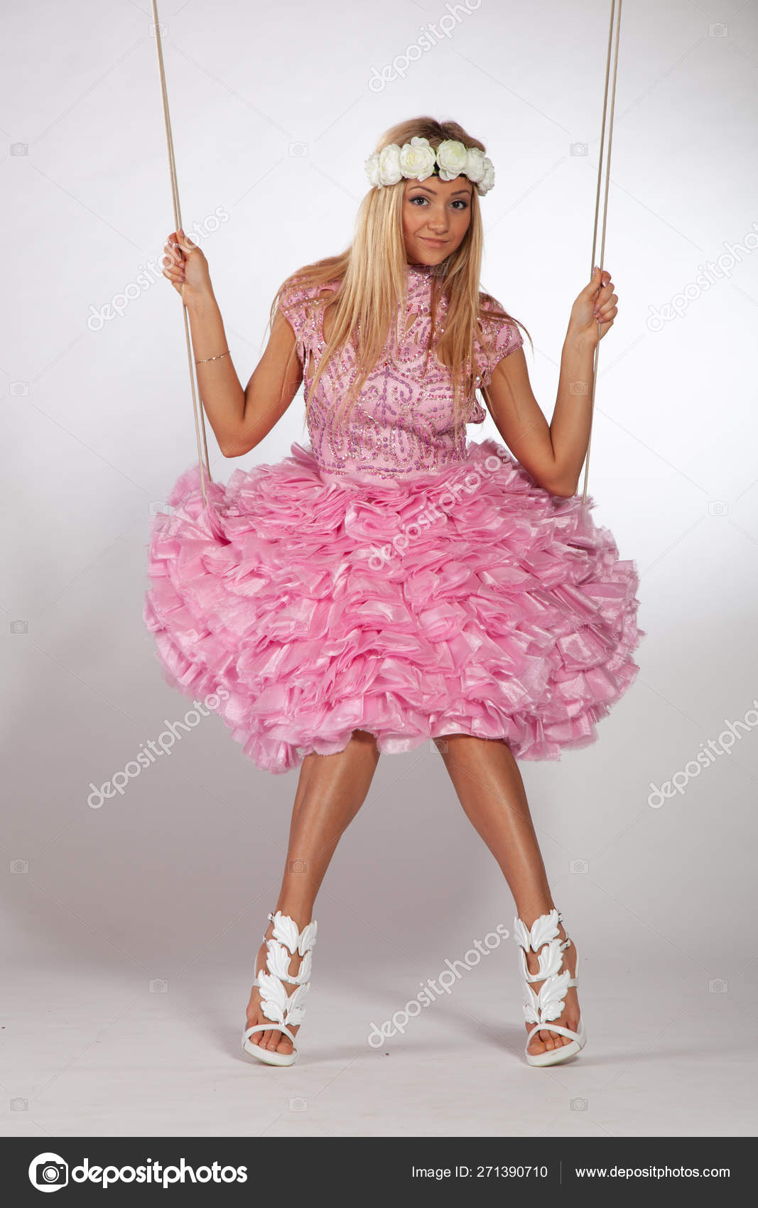 https://st4.depositphotos.com/10086424/27139/i/1600/depositphotos_271390710-stock-photo-girl-swinging-swing-studio-pink.jpg