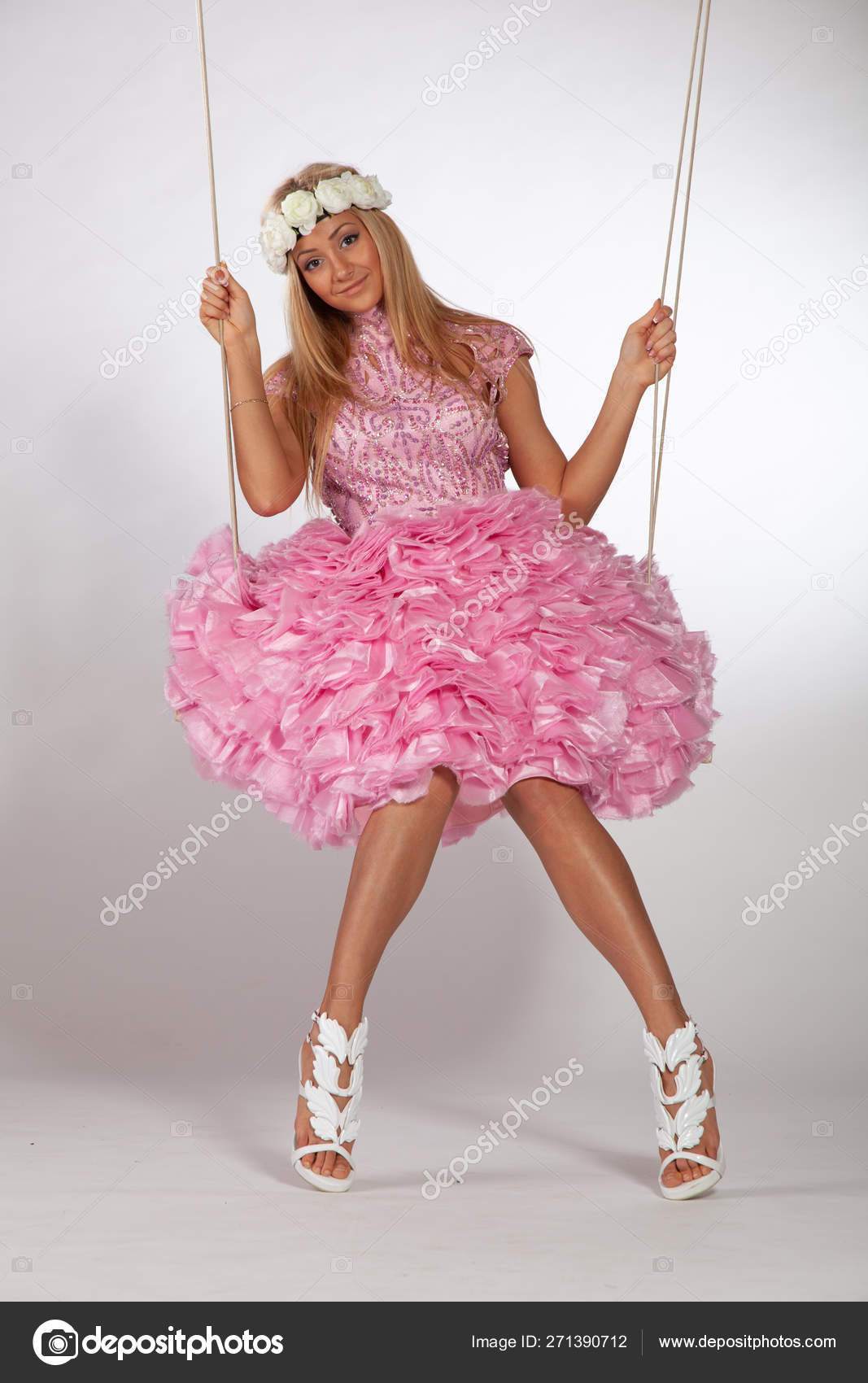 https://st4.depositphotos.com/10086424/27139/i/1600/depositphotos_271390712-stock-photo-girl-swinging-swing-studio-pink.jpg