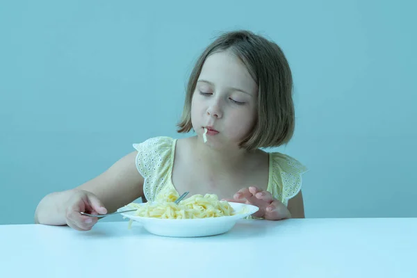 Little Girl Eating Pasta Sitting Table Yellow Dress — Stock Photo, Image