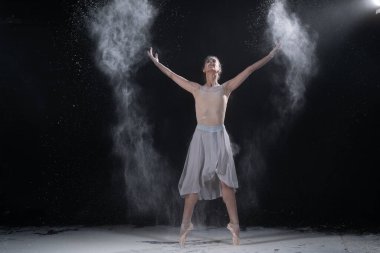 Stüdyoda beyaz unla dans eden balerin.