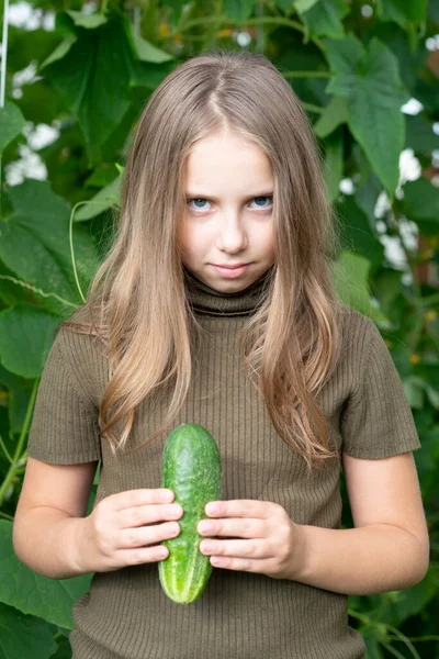 Little Girl Holding Green Cucumber Her Hands Standing Green Sweater — Stock Photo, Image