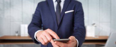 Modern cep telefonu üzerinde arka plan bulanık kullanarak iş adamı