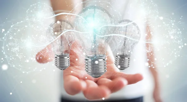 Businessman on blurred background connecting modern lightbulbs with connections 3D rendering