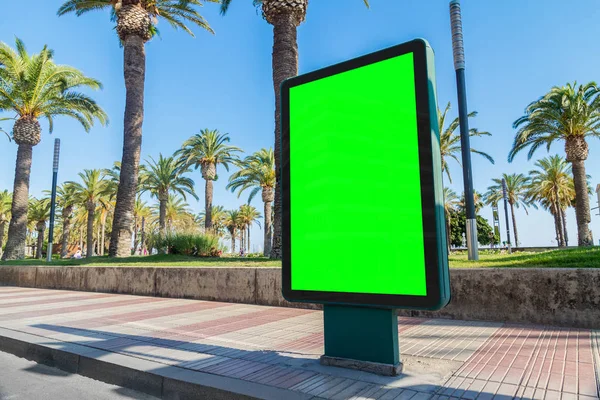 Outdoor billboard advertisement in seaside resort city with palms mockup