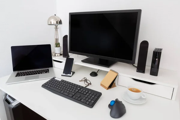 Computer and devices on modern white desk bright interior 3D rendering