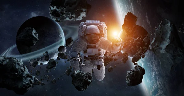 Astronaut floating in space in front of planets 3D rendering elements of this image furnished by NASA
