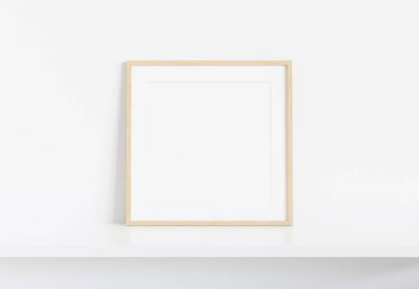 İç mockup beyaz rafa yaslanmış ahşap kare çerçeve 