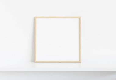 İç mockup beyaz rafa yaslanmış ahşap kare çerçeve 