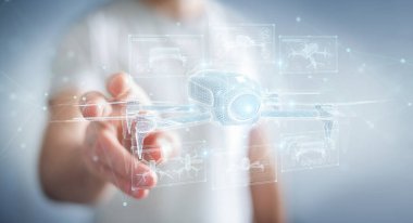 Bulanık arka plan tutuşu ve ellerindeki holografik insansız hava aracı projeksiyonuna dokunan iş adamı