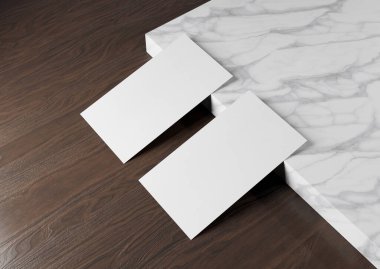 Tahta arka planda iki beyaz Amerikan kartviziti. Önde ve arkada boş bir yüzey üzerinde duran Amerikan büyüklüğünde bir kartvizit.