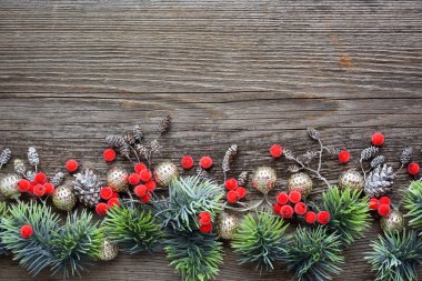 Noel süsleri ve ladin dalları ahşap bir masada. Üst görünüm, boşluğu kopyala. Noel veya Yeni Yıl tebrik kartı.