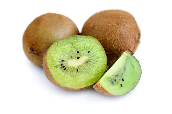 Whole kiwi fruit and his sliced segments isolated on white Royalty Free Stock Photos