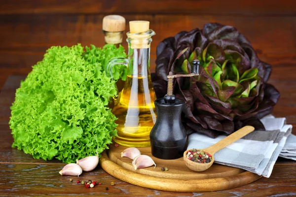 Färsk grön och röd sallad, olja, kryddor på trä bakgrund — Stockfoto