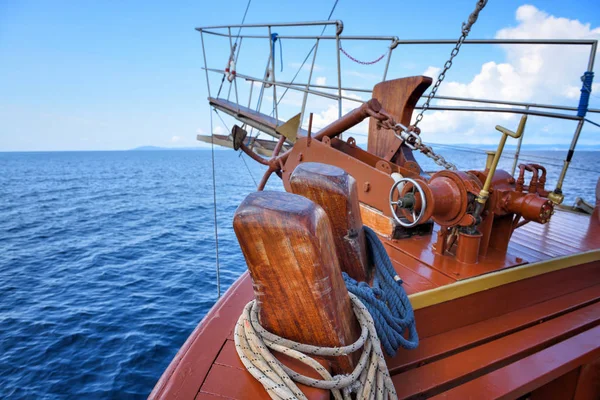 A anchor, ropes and bow of a wooden sailing yacht