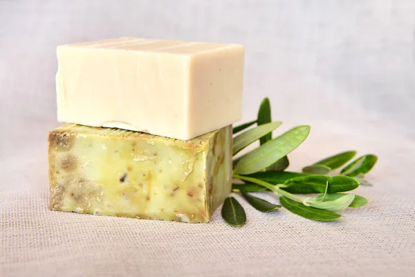 Natural olive soap and olive branch on gunny background — Stock Photo, Image