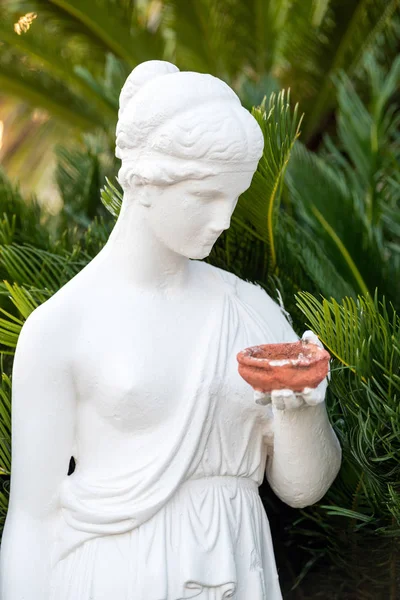 Female statue in the garden decorated — Stock Photo, Image