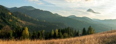 Mavili üzerinde renkli gün batımıyla inanılmaz bir dağ manzarası.