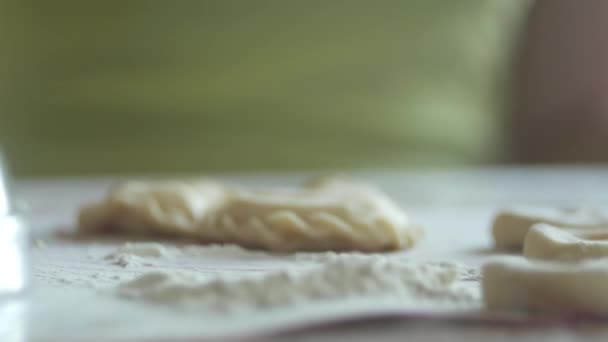 Unrecognizable woman is heaping round pieces of a dough in a flour for making dumplings, 4K close-up — Stock Video