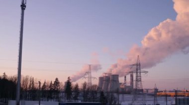 Duman ve bir termal elektrik İstasyonu 4 k soldan sağa kamera hareket yavaş mo üç borulardan kış göğe yükselen Buhar