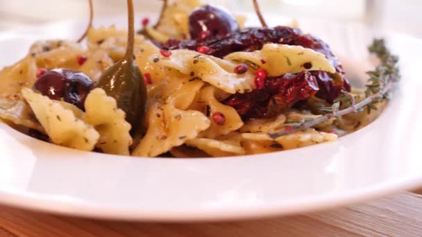 Slow Motion Shooting Farfalle Pasta Sun Dried Tomatoes Capers Decorated — ストック動画