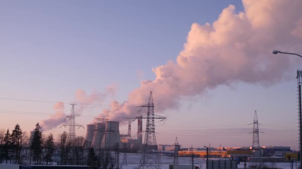 Smoke and steam from pipes of a power station rising up in winter sky 4K slow mo — Stock Video