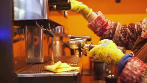 Woman baristas hands in yellow gloves making coffee in modern coffee machine on a kitchen of the cafe 4K slow motion close up video — Stock Video