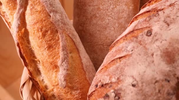 Breads and other bakery in decorative basket in background close up slow motion medium shot in 4K — Stock Video