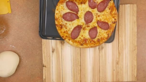 A pizza apetecível quente do pepperoni desloca-se da panela à mesa de madeira sem nenhum homem ou mulher na armação no movimento lento fechar acima a vista superior vídeo 4K — Vídeo de Stock