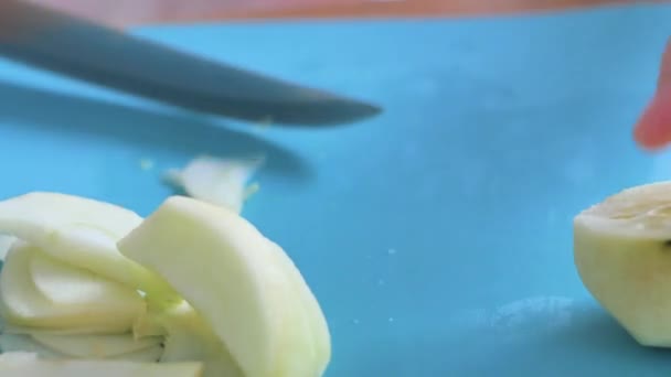 Young woman cutting an apple kitchen — Stock Video