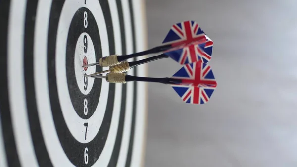 Dart hitting bulls eye, single shot bulls-eye. Concept of successful business ideas hitting the exact center of the target. Perfect performance of the task and superiority over the rivals.