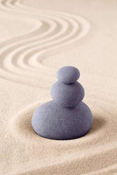 Stone stack, Japanese zen sand garden with pile of rocks. Concept for balance and purity.