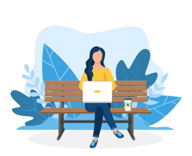 Dizüstü bilgisayarı olan kadın doğada oturuyor.